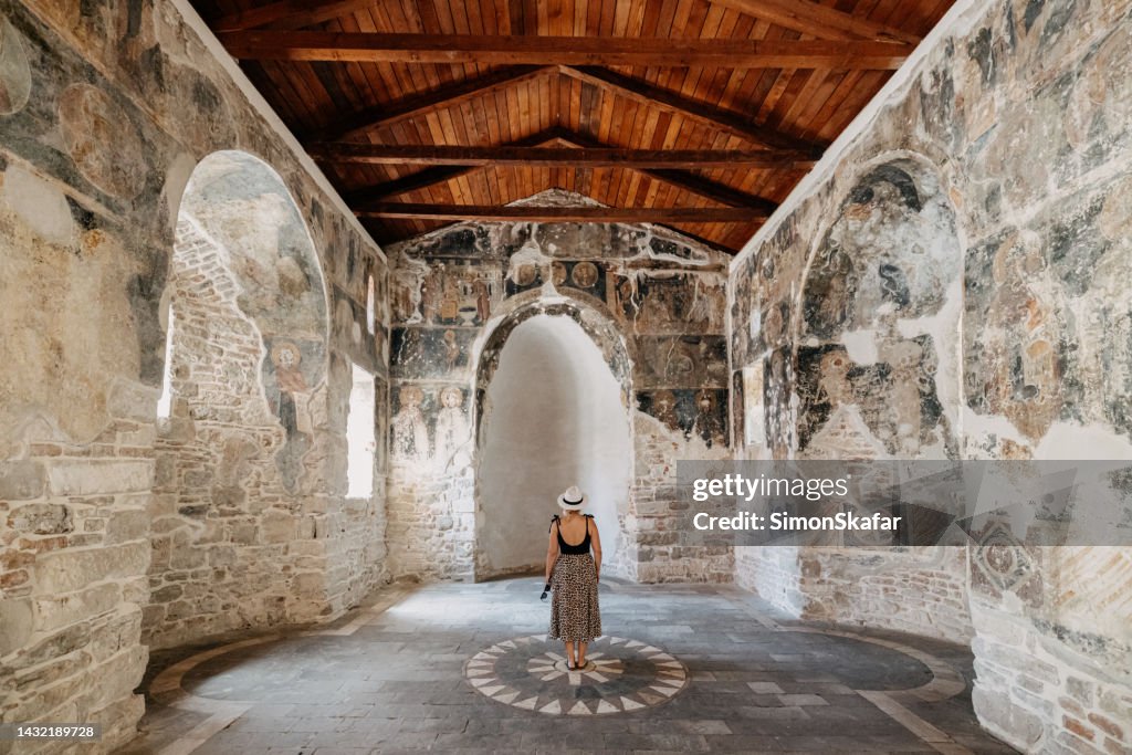 Tourist exploring ancient Ardenica Monastery during summer vacation