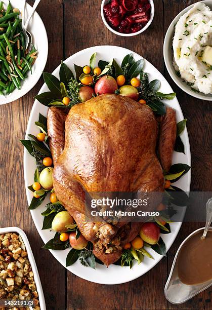 turkey, stuffing, and gravy dishes on wood surface - christmas table turkey ストックフォトと画像