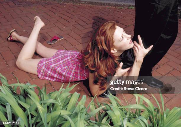 woman clinging on to man's leg - clingy girlfriend stock pictures, royalty-free photos & images