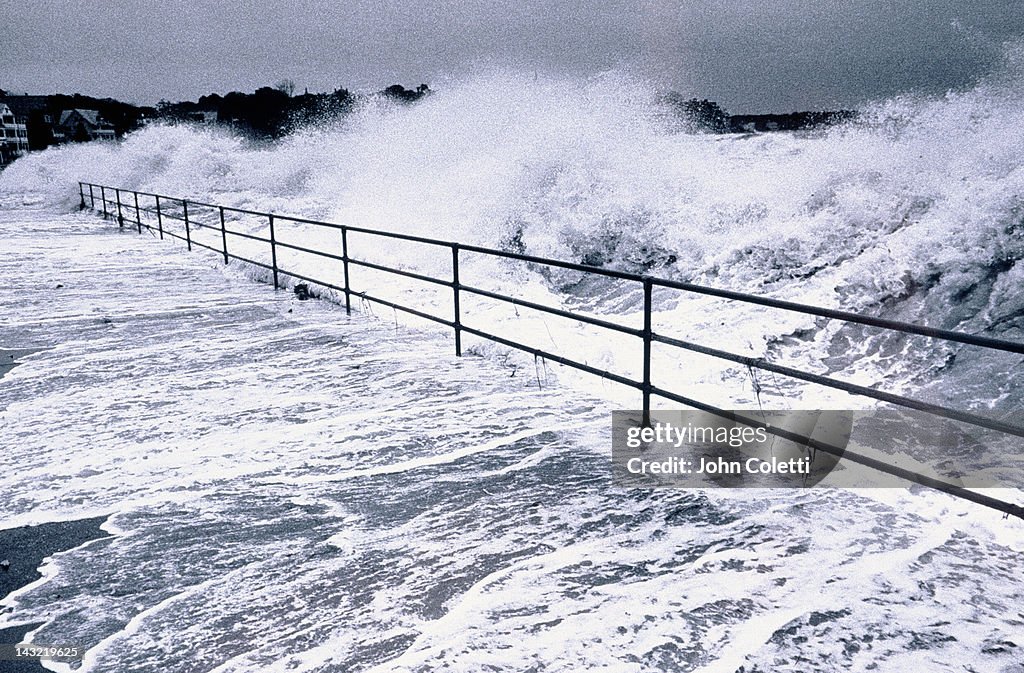 Hurricane winds blow waves onto streets