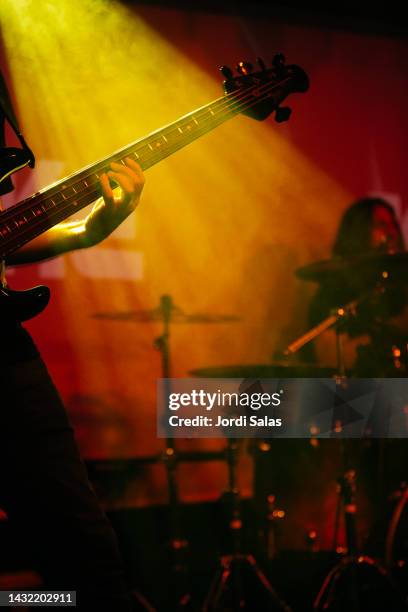 rock band performing on stage at night club - heavy metal guitarist stock pictures, royalty-free photos & images