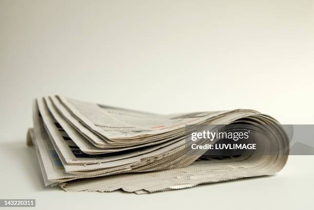 folded newspaper - newspaper stock-fotos und bilder