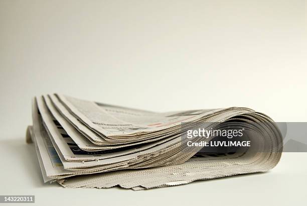folded newspaper - newspaper stock pictures, royalty-free photos & images