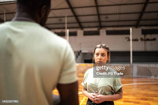 soldiers talking while working in a sheltering at a community center - army camp stock pictures, royalty-free photos & images