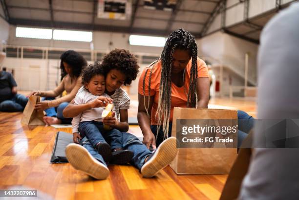 family of refugee in a sheltering - homeless family stock pictures, royalty-free photos & images