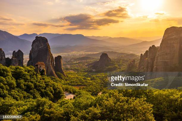 scenic view of meteora monastery against cloudy sky during sunset - roman landscapes stock pictures, royalty-free photos & images