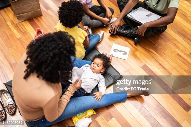 family of refugee in a sheltering at a community center - 1 year poor african boy stock pictures, royalty-free photos & images