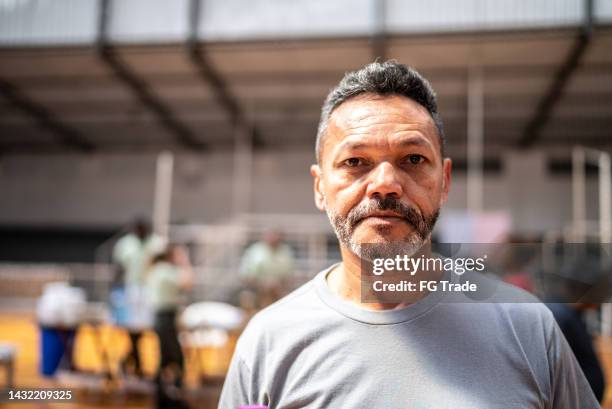 portrait of a mature man at a community center - refugee camp imagens e fotografias de stock