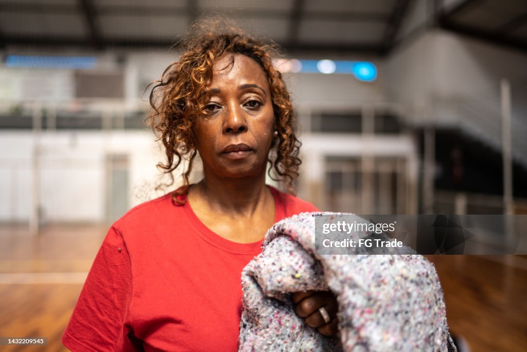 Ritratto di una donna anziana che tiene una coperta in un centro comunitario