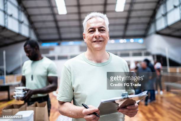portrait of a male soldier holding a clipboard at a gymnasium - politics and government stock pictures, royalty-free photos & images