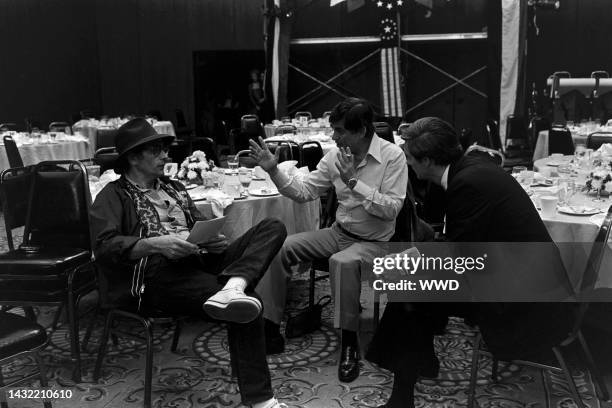 Director Jerry Schatzberg, producer Martin Bregman, and Alan Alda prepare for filming during production of "The Seduction of Joe Tynan" in Baltimore,...