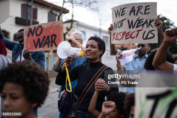 people protesting in the street - society of peace stock pictures, royalty-free photos & images