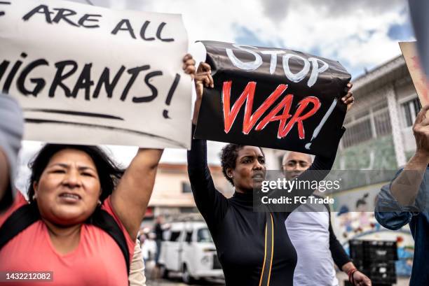 people protesting in the street - holding poster stock pictures, royalty-free photos & images