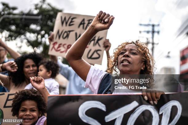 senior woman protesting in the street - childrens justice campaign event stock pictures, royalty-free photos & images