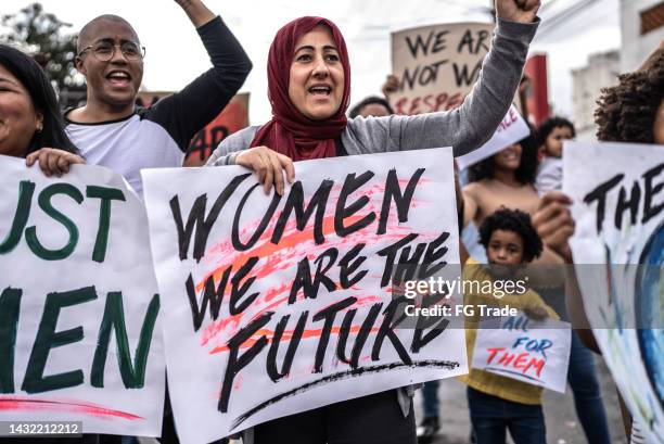 people protesting in the street - womens day stock pictures, royalty-free photos & images