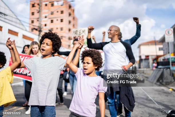 people protesting in the street - kids marching stock pictures, royalty-free photos & images