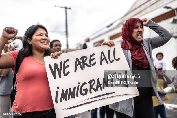 refugee woman protesting in the street - refugee protest stock pictures, royalty-free photos & images