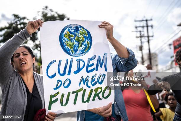 brazilian environmentalists protesting about planet earth outdoors - earth activist stock pictures, royalty-free photos & images