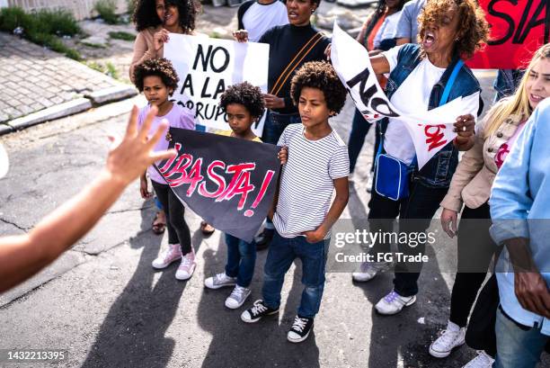 group of people protesting in the streets - childrens justice campaign event imagens e fotografias de stock