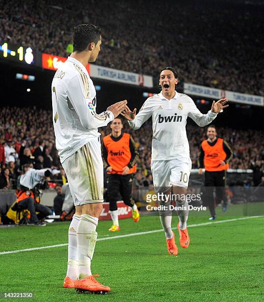 Cristiano Ronaldo of Real Madrid CF celebrates with Mesut Ozil after scoring his team's 2nd goal during the La Liga match between FC Barcelona and...