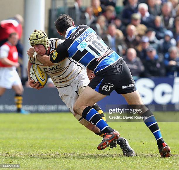 Richard Birkett of Wasps is tackled by Stephen Donald during the Aviva Premiership match between Bath and London Wasps at the Recreation Ground on...