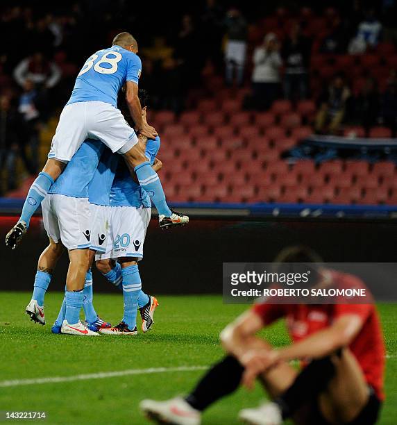 Napoli's players celebrate a goal during an Italian Serie A football match between SSC Napoli vs Novara at San Paolo Stadium in Naples on April 21,...