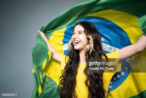 brazilian female fan celebrating on yellow uniform - brazil girls supporters stock pictures, royalty-free photos & images