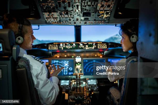 rear view of two pilots flying an commercial airplane jet - pilot bildbanksfoton och bilder