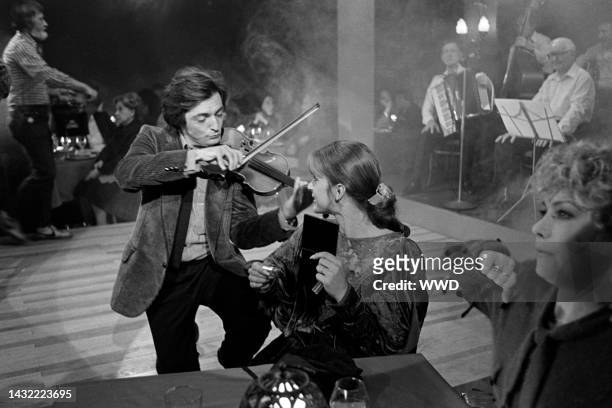 Armand Assante, Nastassja Kinski, and Cassie Yates perform during production of "Unfaithfully Yours" at 20th Century-Fox Studios in Century City,...