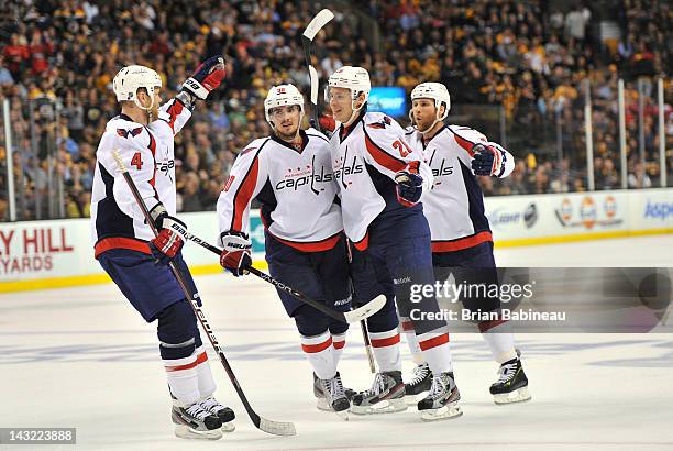 John Erskine, Marcus Johansson, Alexander Semin and Dennis Wideman of the Washington Capitals celebrate a goal against the Boston Bruins in Game Five...