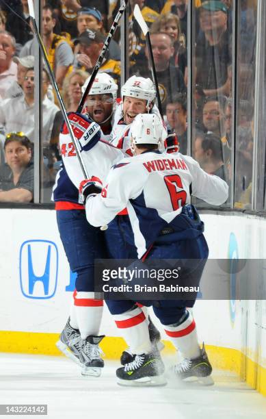 Joel Ward, Mike Knuble and Dennis Wideman of the Washington Capitals celebrate a goal against the Boston Bruins in Game Five of the Eastern...