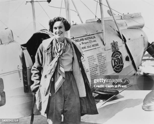 New Zealand aviator Jean Batten poses beside her De Havilland Gipsy Moth aircraft ahead of the return flight, as Batten attempts to break her...
