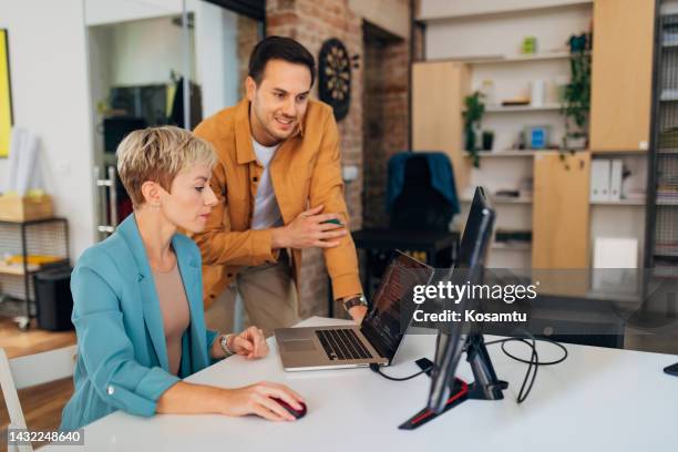 two focused business people working together to solve a coding problem - cybersecurity training stock pictures, royalty-free photos & images