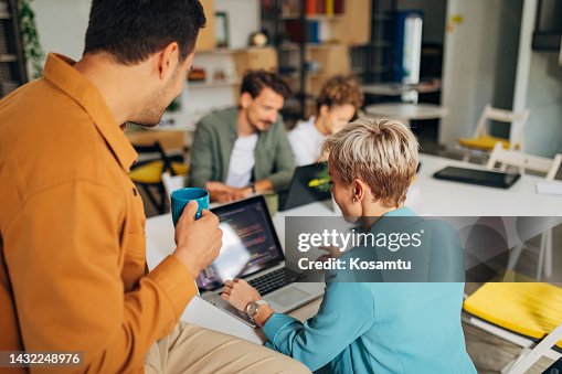 A group of people learn coding techniques while being supervised by a professional programmer A group of people learn coding techniques while being supervised by a professional programmer
