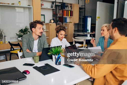 A group of people discuss various techniques of coding programs A group of people discuss various techniques of coding programs