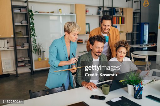 A group of new programmers learn the basics of coding a program A group of new programmers learn the basics of coding a program