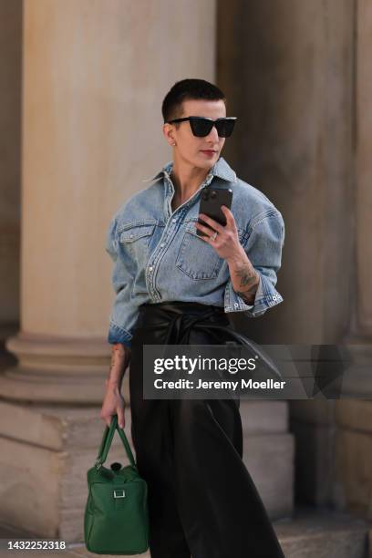 Tereza Brink wearing Wardrobe NYC blue denim oversized jacket, Nanushka black midi leather skirt, Tibi green bag on October 06, 2022 in Hamburg,...