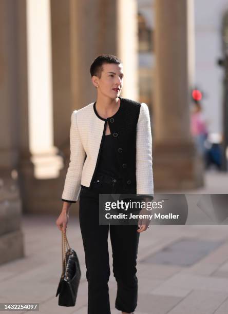 Tereza Brink wearing a black Chanel 2.55 bag, black and white Yves Saint Laurent blazer and Agolde black denim pants on October 06, 2022 in Hamburg,...