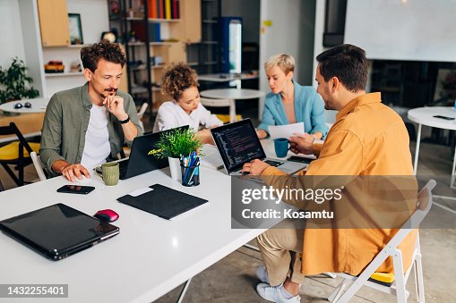 A professional female developer teaches new developers how to code programs A professional female developer teaches new developers how to code programs