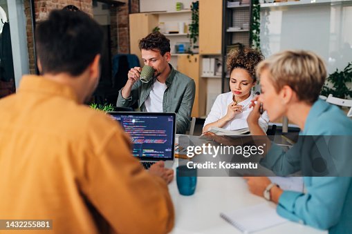 A small group of people collaborate while learning to code A small group of people collaborate while learning to code
