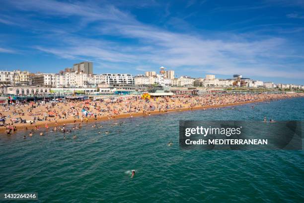 brighton seaside resort beach in a summer sunny blue sky day with tourists in uk - brighton england stock pictures, royalty-free photos & images