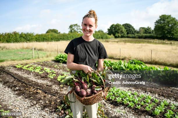 portrait of cheerful young farmer with harvested beets - common beet stock pictures, royalty-free photos & images