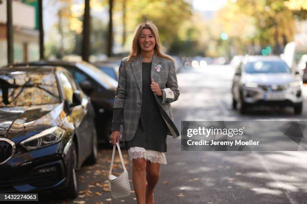 Yasmin von Schlieffen-Nannen wearing white Bottega Veneta bag, grey Valentino dress and grey Golden Goose blazer on October 07, 2022 in Berlin,...