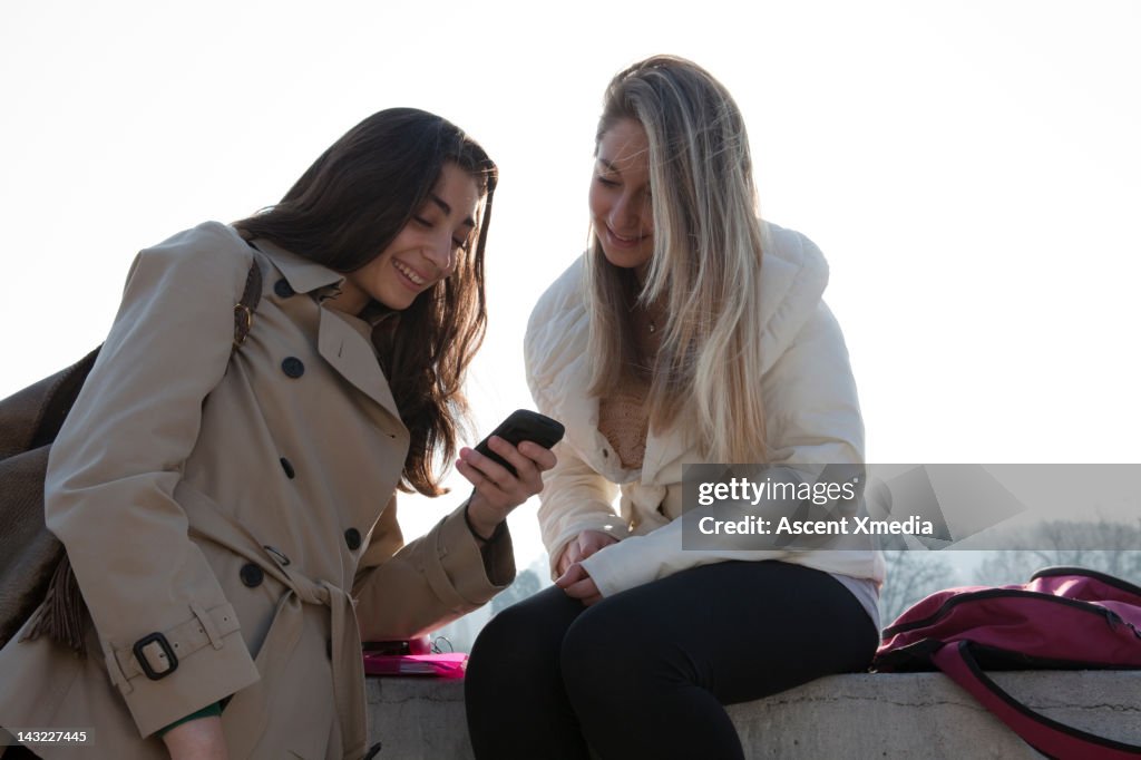 Girl Getting A Message Teenage Girls Check Text Message Marble Railing High-Res Stock Photo ...
