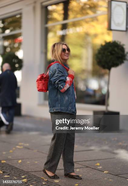 Yasmin von Schlieffen-Nannen wearing black Celine ballerinas, blue Acne Studios jeans jacket, red Essential Antwerp sweater, red Loewe bag, Isabel...