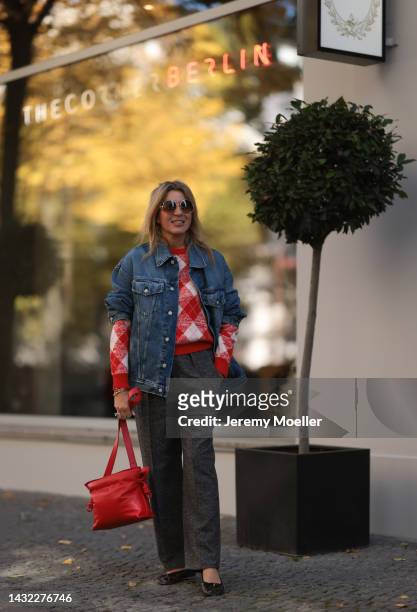 Yasmin von Schlieffen-Nannen wearing black Celine ballerinas, blue Acne Studios jeans jacket, red Essential Antwerp sweater, red Loewe bag, Isabel...