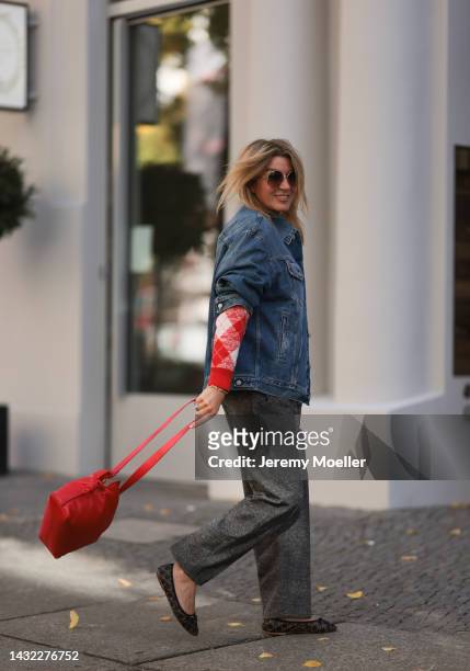 Yasmin von Schlieffen-Nannen wearing black Celine ballerinas, blue Acne Studios jeans jacket, red Essential Antwerp sweater, red Loewe bag, Isabel...