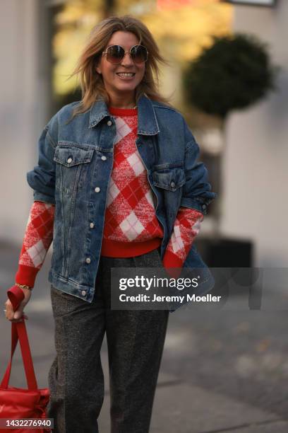 Yasmin von Schlieffen-Nannen wearing blue Acne Studios jeans jacket, red Essential Antwerp sweater, red Loewe bag, Isabel Marant Etoile pants, Loewe...