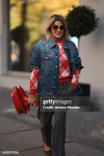 Yasmin von Schlieffen-Nannen wearing blue Acne Studios jeans jacket, red Essential Antwerp sweater, red Loewe bag, Isabel Marant Etoile pants, Loewe...