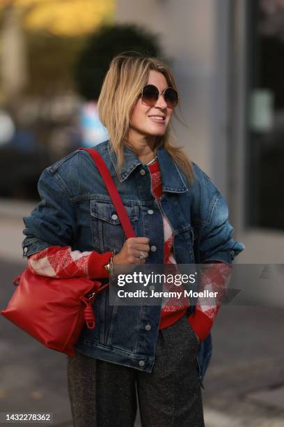 Yasmin von Schlieffen-Nannen wearing blue Acne Studios jeans jacket, red Essential Antwerp sweater, red Loewe bag, Isabel Marant Etoile pants, Loewe...